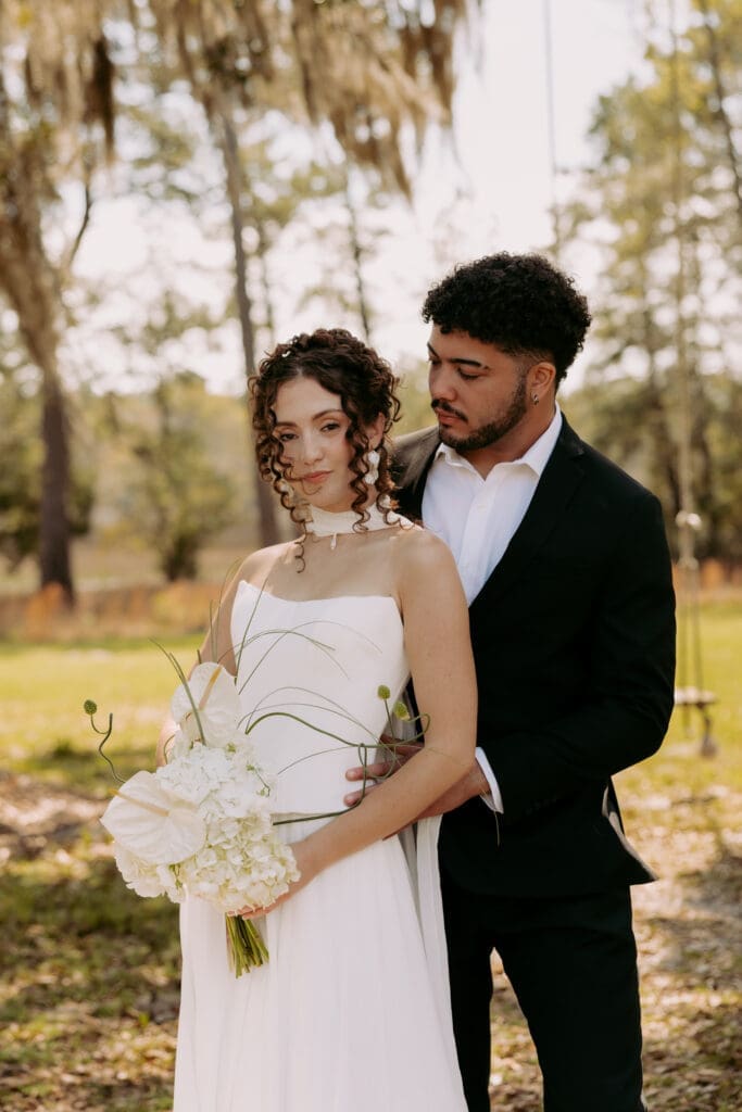 bride and groom overlooking marsh at charleston sc wedding venue pine creek place