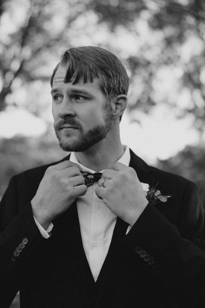 groom adjusting bowtie at pepper pavilion wedding