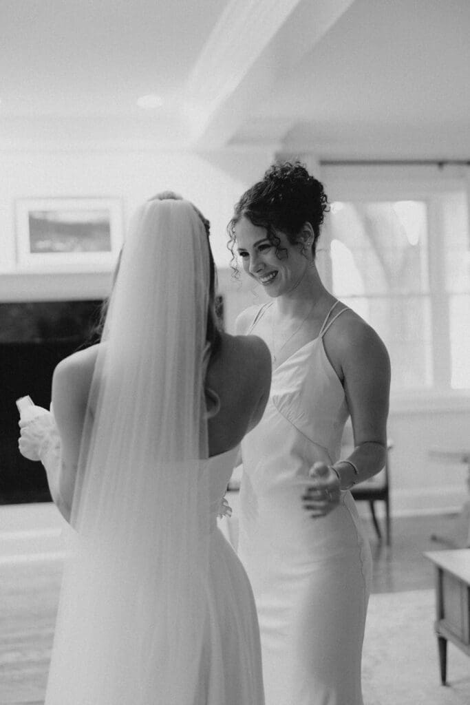 sister giving bride hug after her dress reveal