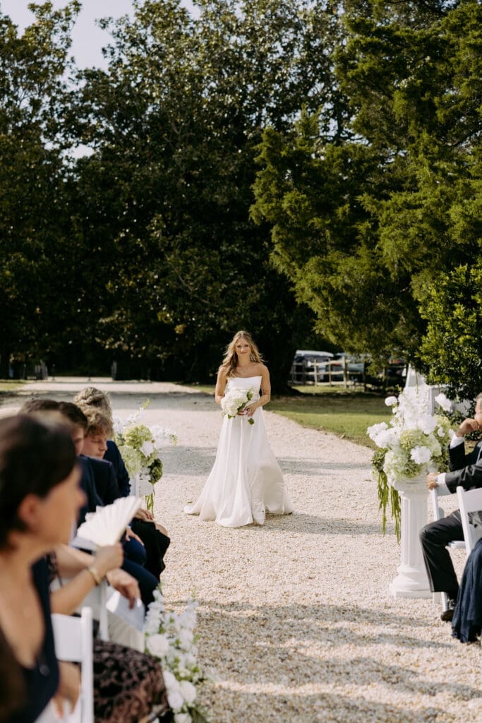 bride walking down the aisle at twin fields estate venue