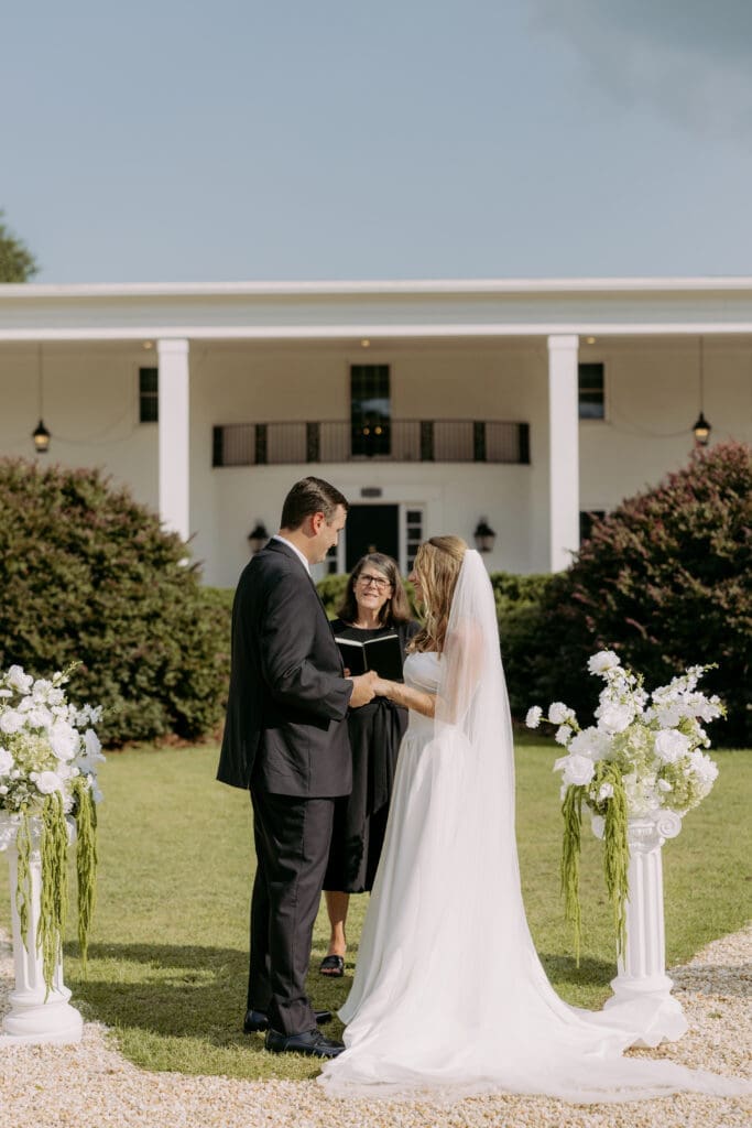 twin fields estate ceremony, bride and groom holding hands